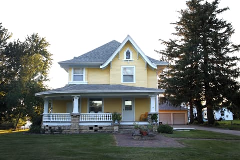 1910 farmhouse.  Wrap around porch on 4.5 acres of land. Summer view.