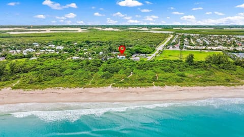 Where turquoise waves meet golden sands - right across the street from our property. ☀️ #BirdsEyeView #BeachLife #CoastalCharm
