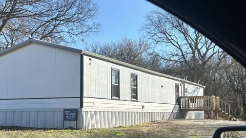 Exterior of property; large lot with gravel driveway, firepit, RV pad
