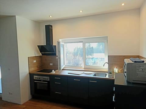 Comfort Apartment | Private kitchen | Microwave, cleaning supplies, dining tables