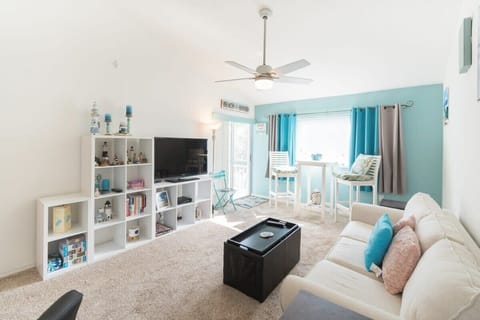 Bright living room with coastal decor and a cozy seating area by the window