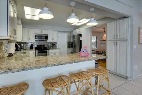 The FULLY STOCKED kitchen features even more bar-top seating and plenty of space to whip up an amazing home-cooked meal of your own.