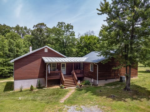 Front photo of cabin in the woods. Midcentury Modern Cabin newly decorated.