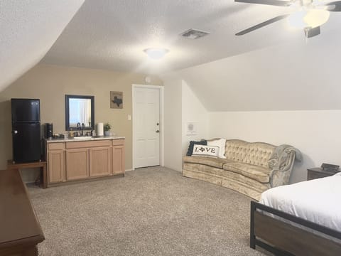 Mini fridge, coffee maker, and sink in the room