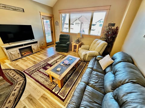 Cozy living area with ample seating & electric fireplace for those chilly nights