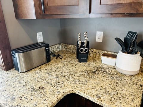 Glass tupperware , salad or mixing bowls are in the cupboard above the toaster.