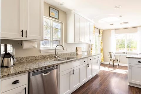 Double sink, garbage disposal, dishwasher, and coffee maker.