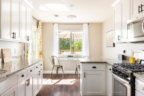 Cafe seating overlooking the yard and bar seating at the end of the kitchen.