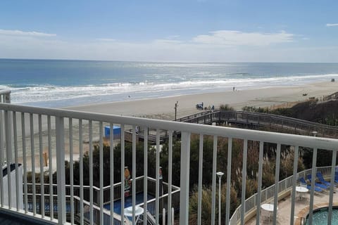 Look out upon your large private balcony with pool and hot tubs below. The oceanfront view is stunning.