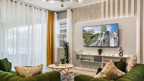 Spacious living room area with cozy sofa, perfect for family reunion.