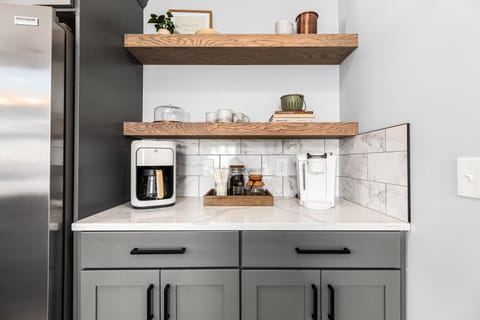 Enjoy our coffee bar with options for everyone! We have a standard coffee pot, Keurig, glass pour over, frother, and bean grinder for all your coffee and tea needs.