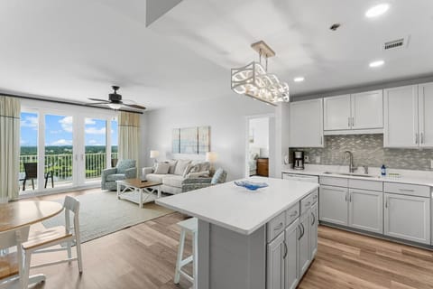 Open Concept Living Room with Sleeper Sofa, Flat Screen TV, Lake Views and Direct Balcony Access plus Open-Concept Fully Equipped Kitchen with Drip Coffee Maker