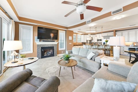 Sink into plush seating by your cozy fireplace, where warm earth tones and modern comfort create your perfect home base.
