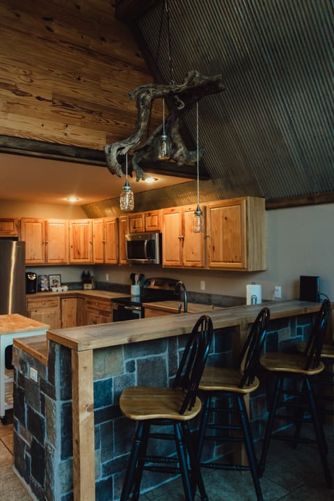 View of kitchen/ bar and unique driftwood chandelier from the Gasconade River
