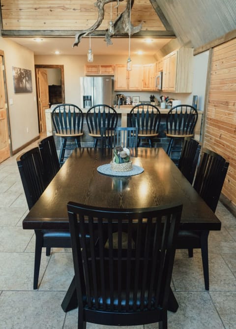 Dining room table, bar, and kitchen