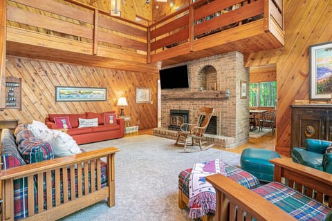 Living room has a Smart TV, sofa sleeper, and seasonal fireplace