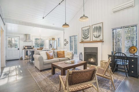 Living dining kitchen space is open with soaring ceilings