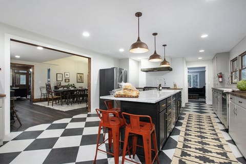 Fully equipped kitchen has casual seating at the center island