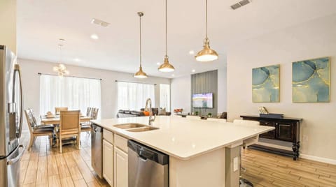 Sleek and spacious kitchen island with sample counter space, idea for meal preparation and casual dining. Bright and inviting atmosphere perfect for any home chef.