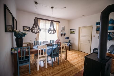 Charming dining area with wood stove, natural light and vintage touches