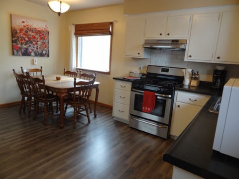 Kitchen with full stove and refrigerator and stocked with more essentials 