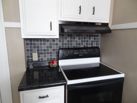 Kitchen has full stove and refrigerator