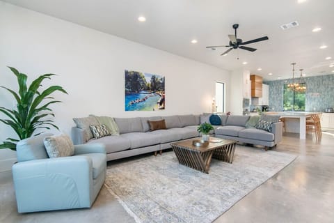 Large living room with oversized couch and Comal River views