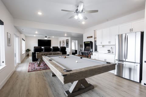 Pool Table, Foosball, kitchenette with refrigerator, arcade, and board games