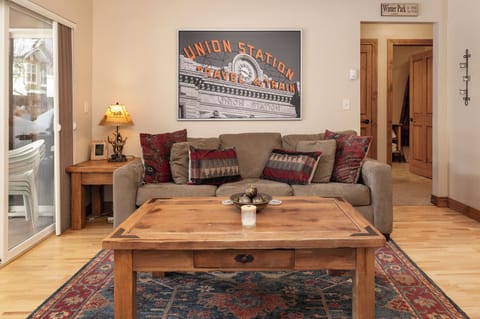 Unwind in your cozy living room featuring plush seating, rustic wood furnishings, and charming mountain-inspired décor.