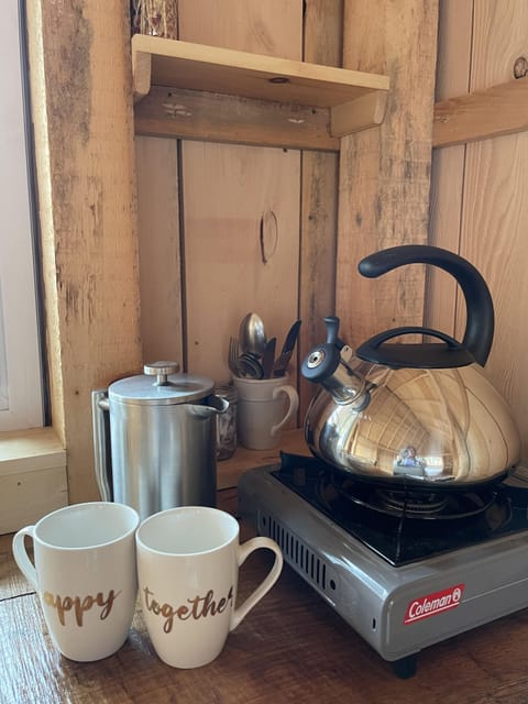 French Press / Coffee / Cream/Sugar / Butane Burner with Tea Kettle in cabin.
