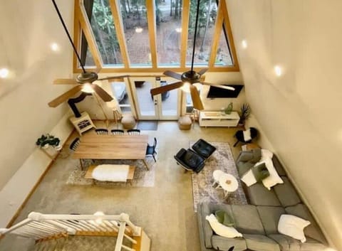 An open concept A-Frame with a beautiful view of the forest. This is a view from the loft located at the top story.