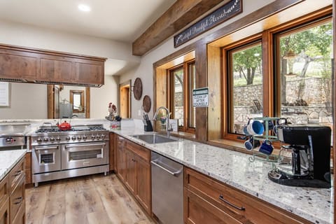 Up-to-date appliances in the kitchen include a microwave, spacious fridge, coffee maker, and dishwasher.