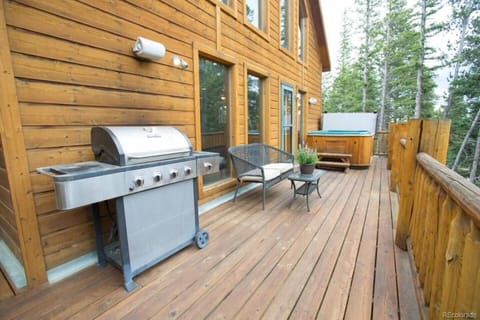 The deck has an open area with a hot tub, grill and sitting area