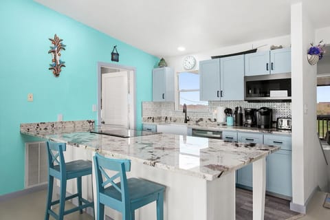 Kitchen with a large island that opens to the living area. 