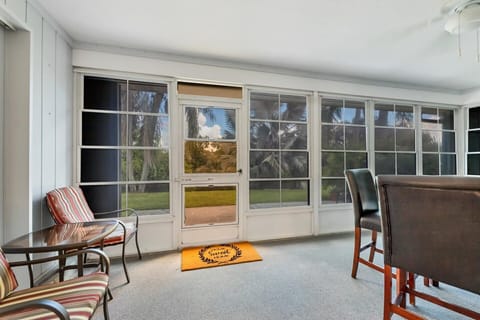 Florida room with windows and outdoor living space inside.