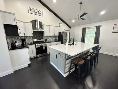 Fully Stocked Kitchen with Island Seating.