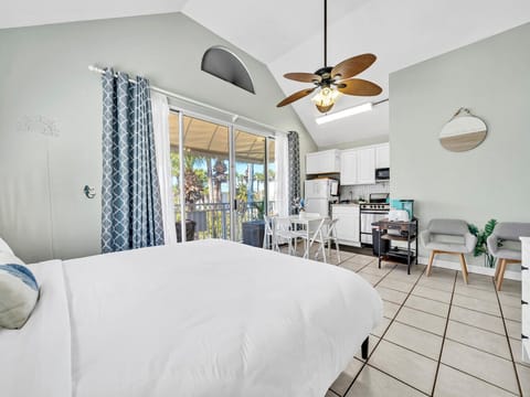 Upstairs, king bed, sitting chairs, dining, kitchen, bunkbeds, bathroom, balcony