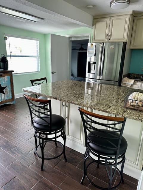 Kitchen with seating at the bar, looking into the queen bedroom