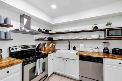 Just like the rest of the house this newly renovated kitchen is both beautiful and functional. Stainless steel appliances, farmhouse kitchen sink, butcher block countertops and very well provisioned. Great for grabbing a small snack or making a meal.