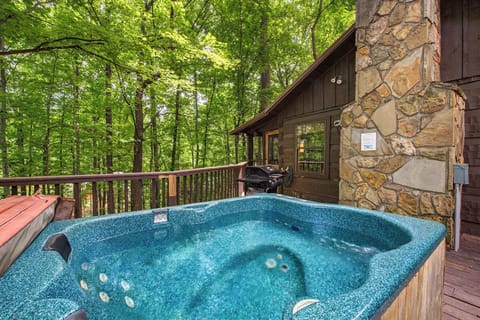 Soak in the sparkling hot tub on your deck, surrounded by lush forest and the soothing sounds of nature. A grill awaits for outdoor dining.