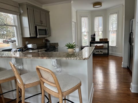 Counter bar with 4 stools and fully stocked kitchen with coffee station
