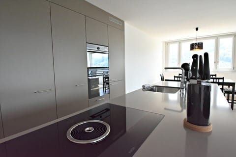 Kitchen island with stovetop and integrated oven.

