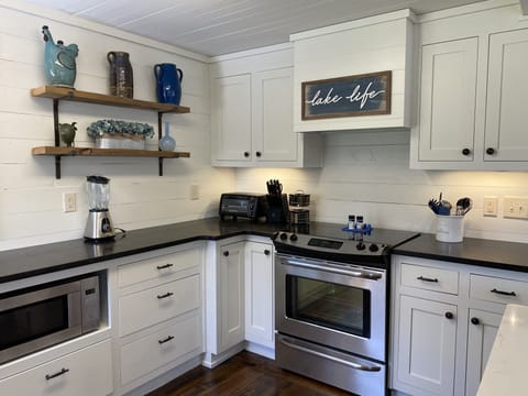 Oven for cooking and glass top electric cooktop. A blender, toaster oven, spices