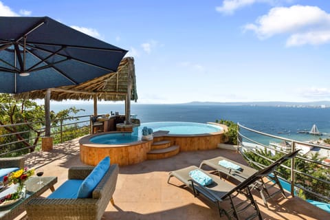 Private patio with heated pool, palapa bar, lounge chairs & covered seating