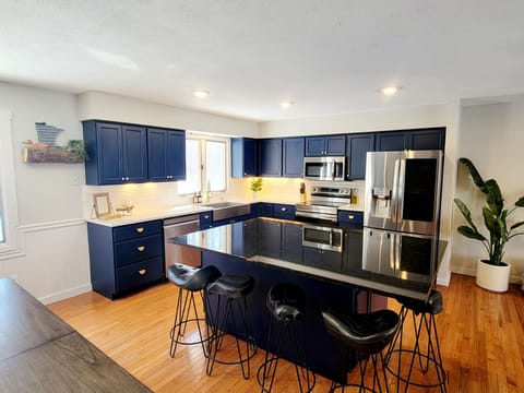 The kitchen has a large center island with Quartz Counters, Stainless Appliances