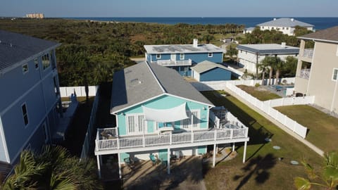 Front view of the home featuring a spacious upper deck and outdoor seating.