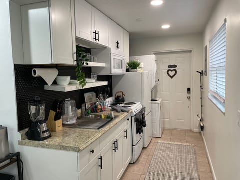 Kitchen also contains washer and dryer.
