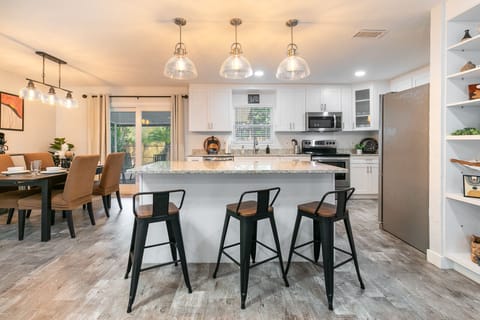 Beautiful, open concept to enjoy dining table, island, and kitchen experience.