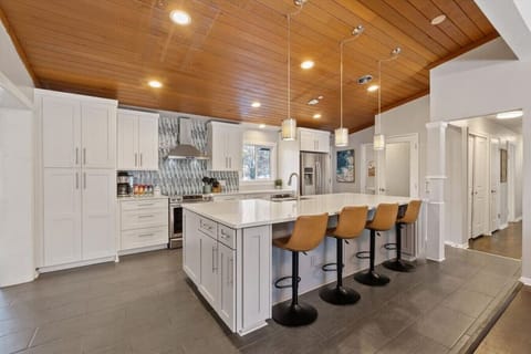 Kitchen with large island for entertaining and fully equipped to cook a meal.