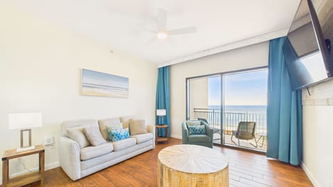 Open concept living area equipped with comfortable furnishings + sleeper sofa and balcony access (sleeps 2)